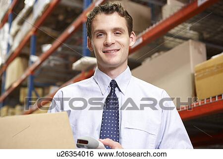 Businessman Scanning Package In Warehouse View Large Photo Image Stock Photograph - Businessman Scanning Package In Warehouse. Fotosearch