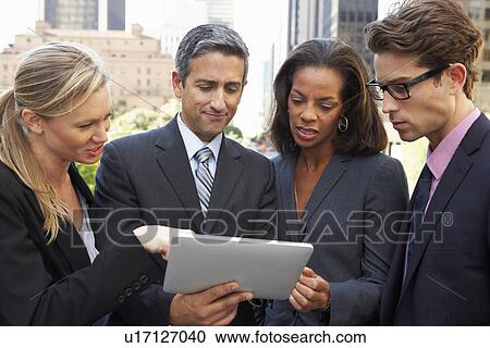 Businessmen And Businesswomen Using Digital Tablet Outside View Large Photo Image Stock Image - Businessmen And Businesswomen Using Digital Tablet Outside . Fotosearch