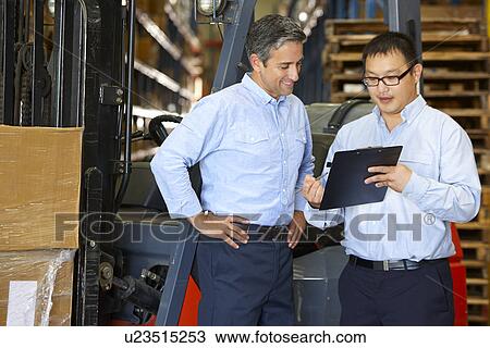 Businessmen Meeting By Fork Lift Truck In Warehouse View Large Photo Image Stock Image - Businessmen Meeting By Fork Lift Truck In Warehouse. Fotosearch