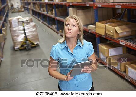 Businesswoman Using Digital Tablet In Distribution Warehouse View Large Photo Image Stock Photograph - Businesswoman Using Digital Tablet In Distribution Warehouse. Fotosearch