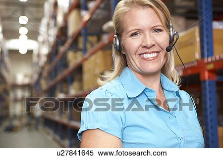Businesswoman Using Headset In Distribution Warehouse View Large Photo Image Stock Photography - Businesswoman Using Headset In Distribution Warehouse. Fotosearch