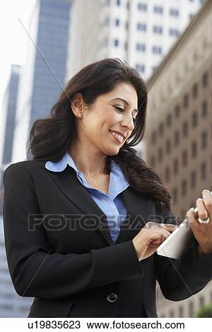 Businesswoman Working On Tablet Computer Outside Office View Large Photo Image Stock Image - Businesswoman Working On Tablet Computer Outside Office. Fotosearch