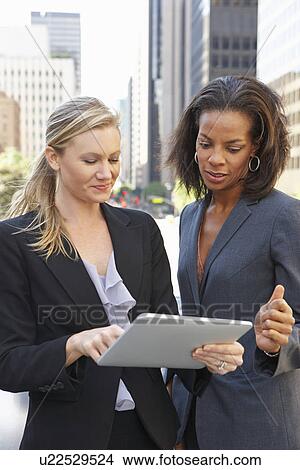 Businesswomen Using Digital Tablet Outside Office View Large Photo Image Picture - Businesswomen Using Digital Tablet Outside Office. Fotosearch