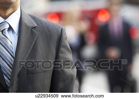 Stock Photo - Close Up Of Businessman Walking Along City Street. Fotosearch
