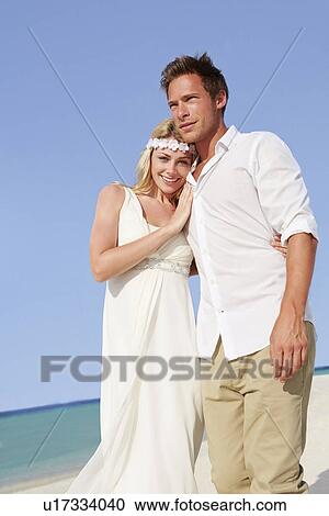 Stock Image - Couple At Beautiful Beach Wedding. Fotosearch
