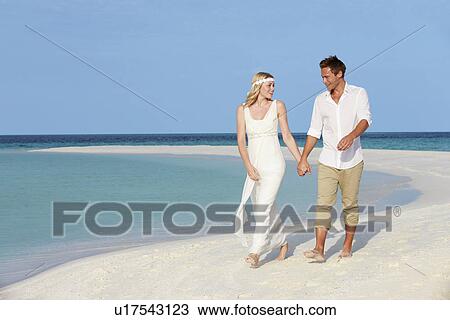 Stock Image - Couple At Beautiful Beach Wedding. Fotosearch