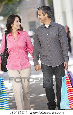 Couple Carrying Shopping Bags On City Street View Large Photo Image Stock Image - Couple Carrying Shopping Bags On City Street. Fotosearch