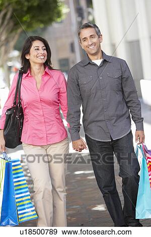 Couple Carrying Shopping Bags On City Street View Large Photo Image Stock Photo - Couple Carrying Shopping Bags On City Street. Fotosearch