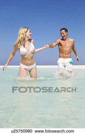 Couple Having Fun In Sea On Beach Holiday View Large Photo Image Stock Image - Couple Having Fun In Sea On Beach Holiday. Fotosearch