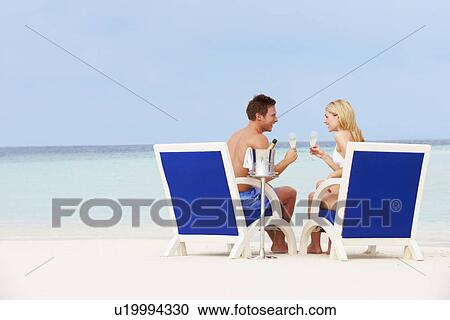 Couple On Beach Relaxing In Chairs And Drinking Chapagne View Large Photo Image Stock Image - Couple On Beach Relaxing In Chairs And Drinking Chapagne. Fotosearch
