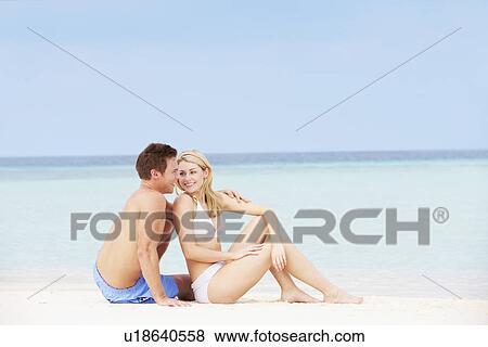 Couple Relaxing On Beautiful Beach Together View Large Photo Image Stock Photo - Couple Relaxing On Beautiful Beach Together. Fotosearch