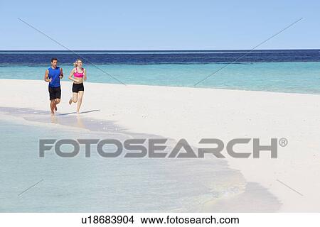 Picture - Couple Running On Beautiful Beach. Fotosearch
