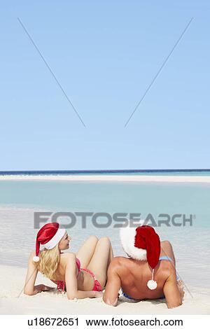 Couple Sitting On Beach Wearing Santa Hats View Large Photo Image Stock Image - Couple Sitting On Beach Wearing Santa Hats. Fotosearch