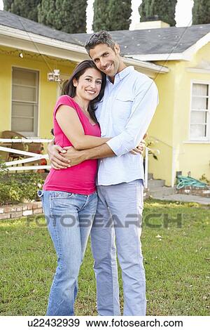 Couple Standing Outside Suburban Home View Large Photo Image Stock Photo - Couple Standing Outside Suburban Home. Fotosearch