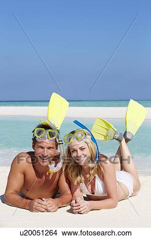Picture - Couple With Snorkels Enjoying Beach Holiday. Fotosearch