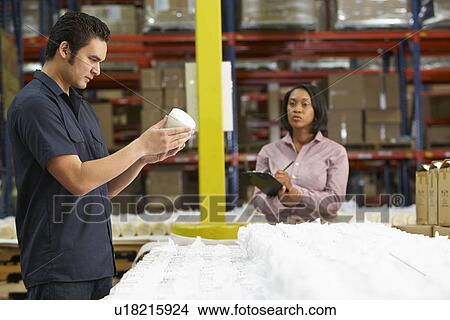 Picture - Factory Worker And Manager Checking Goods On Production Line. Fotosearch