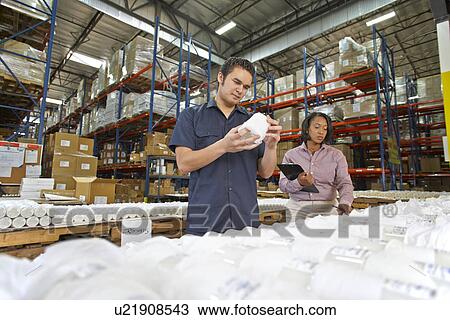 Stock Image - Factory Worker And Manager Checking Goods On Production Line. Fotosearch