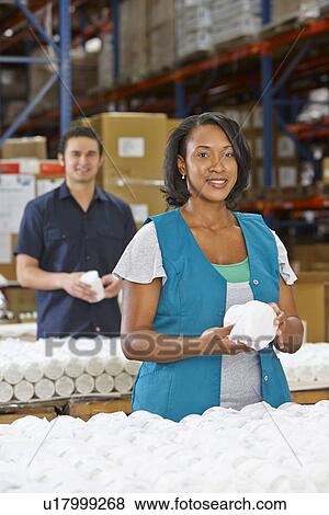 Stock Photo - Factory Worker Checking Goods On Production Line. Fotosearch