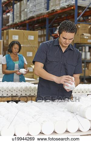 Factory Worker Checking Goods On Production Line View Large Photo Image Stock Photo - Factory Worker Checking Goods On Production Line. Fotosearch