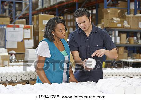 Stock Photography - Factory Worker Training Colleague On Production Line. Fotosearch