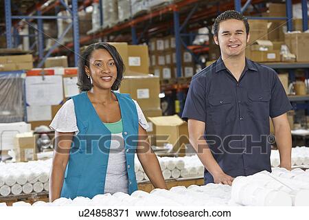 Stock Image - Factory Workers Checking Goods On Production Line. Fotosearch