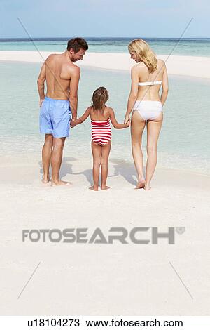 Stock Image - Family Having Fun In Sea On Beach Holiday. Fotosearch