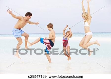 Stock Photo - Family Having Fun In Sea On Beach Holiday. Fotosearch