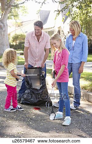 Stock Photo - Family Picking Up Litter In Suburban Street. Fotosearch