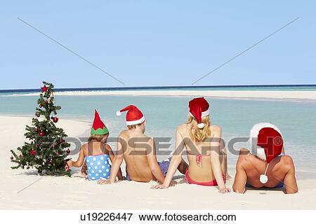Family Sitting On Beach With Christmas Tree And Hats View Large Photo Image Stock Photo - Family Sitting On Beach With Christmas Tree And Hats. Fotosearch