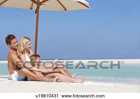 Family Sitting Under Umbrella On Beach Holiday View Large Photo Image Stock Image - Family Sitting Under Umbrella On Beach Holiday. Fotosearch