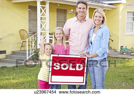 Family Standing By Sold Sign Outside Home View Large Photo Image Picture - Family Standing By Sold Sign Outside Home. Fotosearch