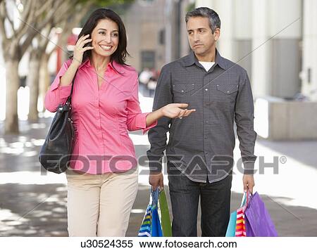 Fed Up Man Carrying Partners Shopping Bags On City Street View Large Photo Image Stock Photography - Fed Up Man Carrying Partners Shopping Bags On City Street. Fotosearch