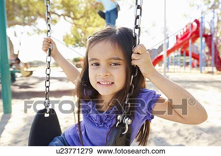 Girl On Swing In Park View Large Photo Image Stock Photo - Girl On Swing In Park. Fotosearch