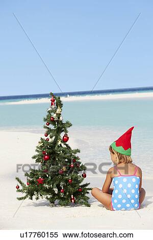 Girl Sitting On Beach With Christmas Tree And Hat View Large Photo Image Stock Photography - Girl Sitting On Beach With Christmas Tree And Hat. Fotosearch