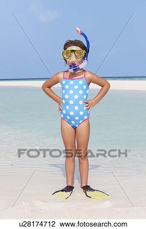 Stock Image - Girl Standing On Beach Wearing Snorkel And Flippers. Fotosearch