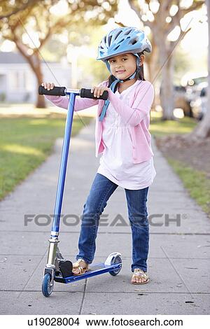 Girl Wearing Safety Helmet Riding Scooter View Large Photo Image Picture - Girl Wearing Safety Helmet Riding Scooter. Fotosearch