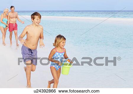 Grandparents And Grandchildren Having Fun On Beach Holiday View Large Photo Image Stock Photograph - Grandparents And Grandchildren Having Fun On Beach Holiday. Fotosearch