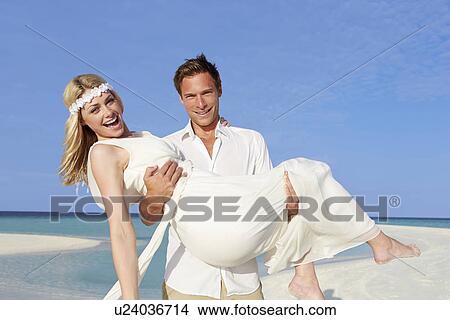 Groom Carrying Bride At Beautiful Beach Wedding View Large Photo Image Picture - Groom Carrying Bride At Beautiful Beach Wedding. Fotosearch