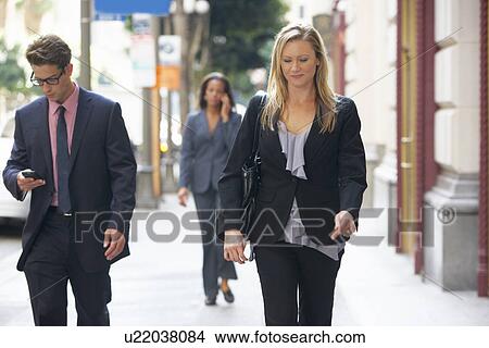 Group Of Businesspeople Walking Along Street View Large Photo Image Picture - Group Of Businesspeople Walking Along Street. Fotosearch