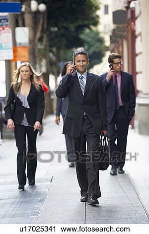 Group Of Businesspeople Walking Along Street View Large Photo Image Stock Image - Group Of Businesspeople Walking Along Street. Fotosearch