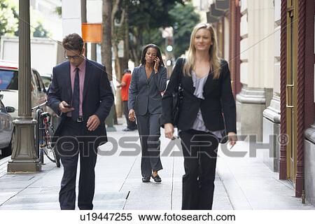 Group Of Businesspeople Walking Along Street View Large Photo Image Stock Photography - Group Of Businesspeople Walking Along Street. Fotosearch