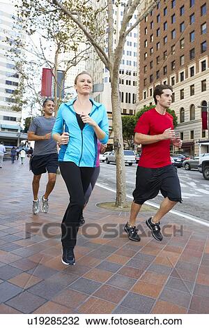 Stock Image - Group Of Runners On Urban Street. Fotosearch