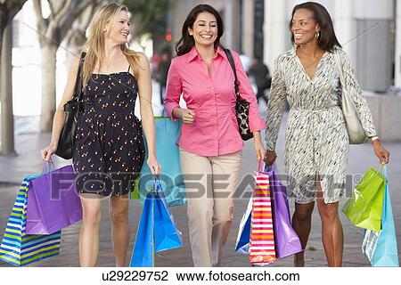 Stock Image - Group Of Women Carrying Shopping Bags On City Street. Fotosearch