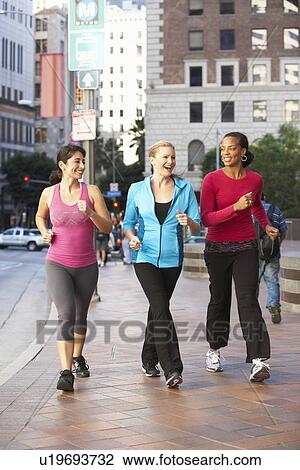Stock Image - Group Of Women Power Walking On Urban Street. Fotosearch