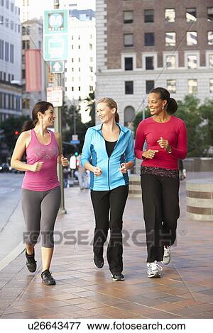 Stock Photo - Group Of Women Power Walking On Urban Street. Fotosearch