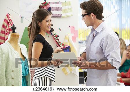 Stock Photo - Man And Woman Meeting In Fashion Design Studio . Fotosearch
