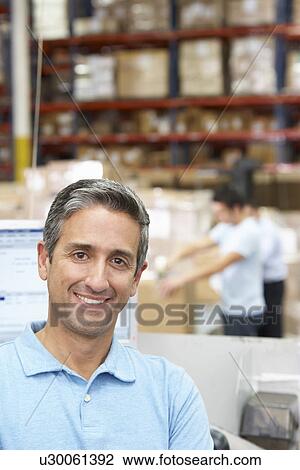 Man At Computer Terminal In Distribution Warehouse View Large Photo Image Stock Image - Man At Computer Terminal In Distribution Warehouse. Fotosearch