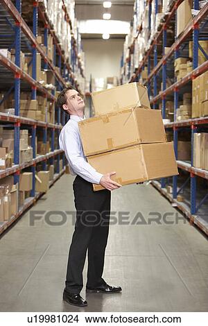 Man Carrying Boxes In Warehouse View Large Photo Image Picture - Man Carrying Boxes In Warehouse . Fotosearch