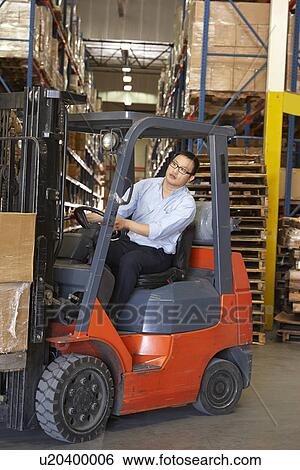 Man Driving Fork Lift Truck In Warehouse View Large Photo Image Stock Photograph - Man Driving Fork Lift Truck In Warehouse. Fotosearch
