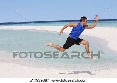 Stock Photo - Man Exercising On Beautiful Beach. Fotosearch